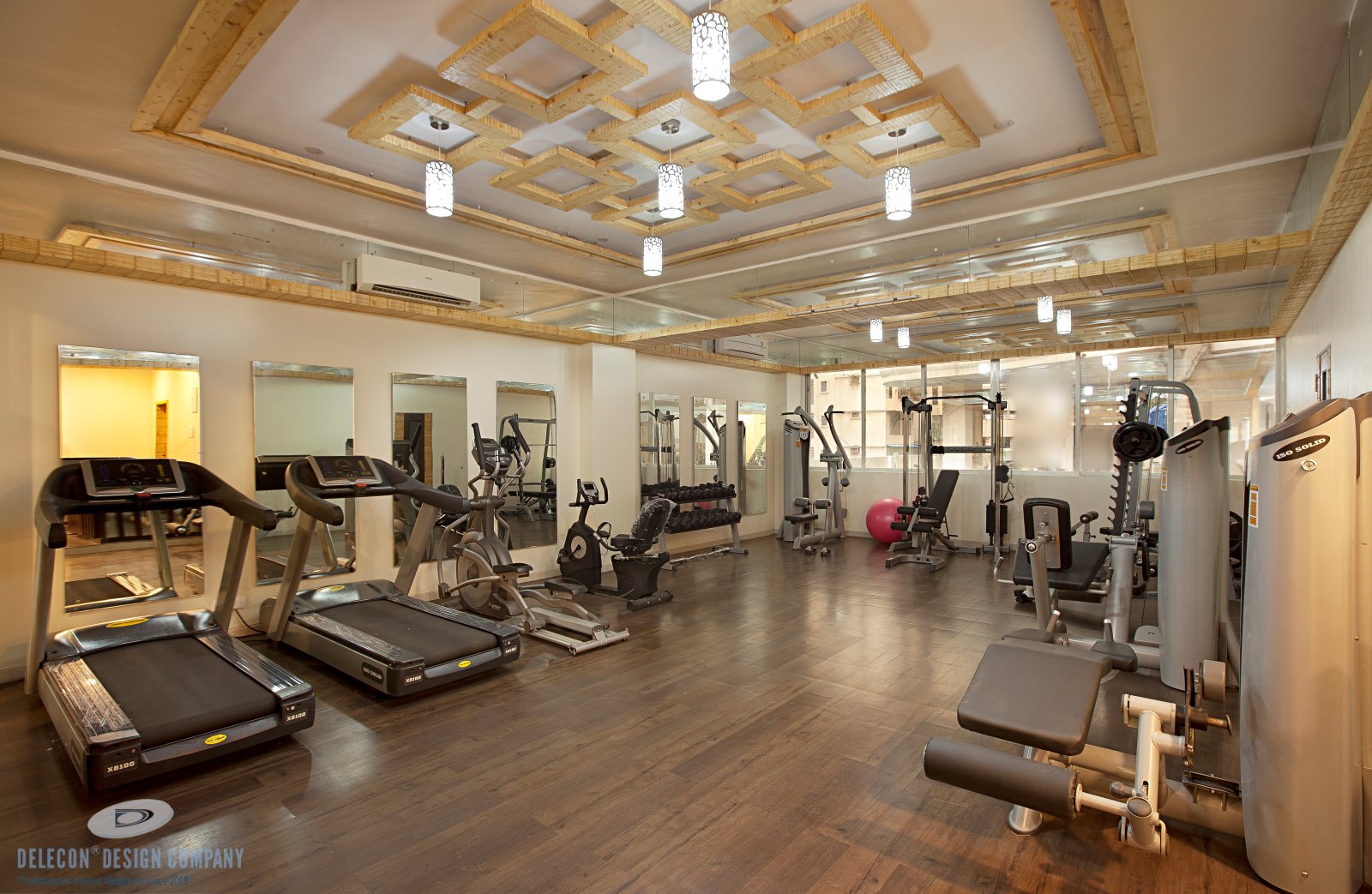 Wooden theme gymnasium design with mirrors and equipment