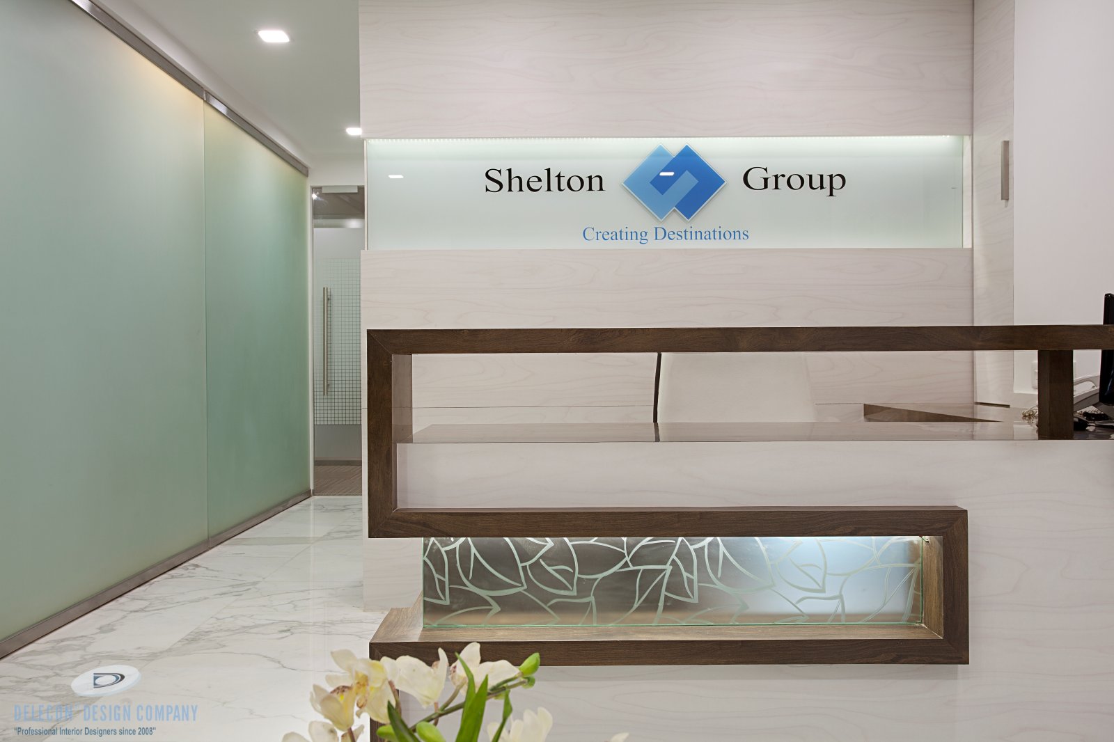 Reception area with waiting zone and glass partition at Shelton Group